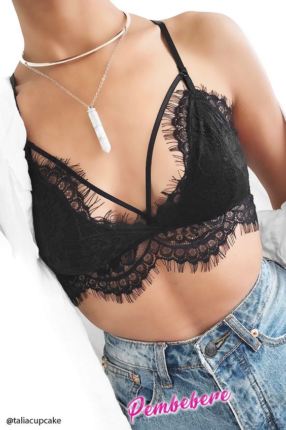 A lightly-lined knit bralette featuring eyelash lace trim, a strappy cutout front, adjustable straps, and a crisscross back.